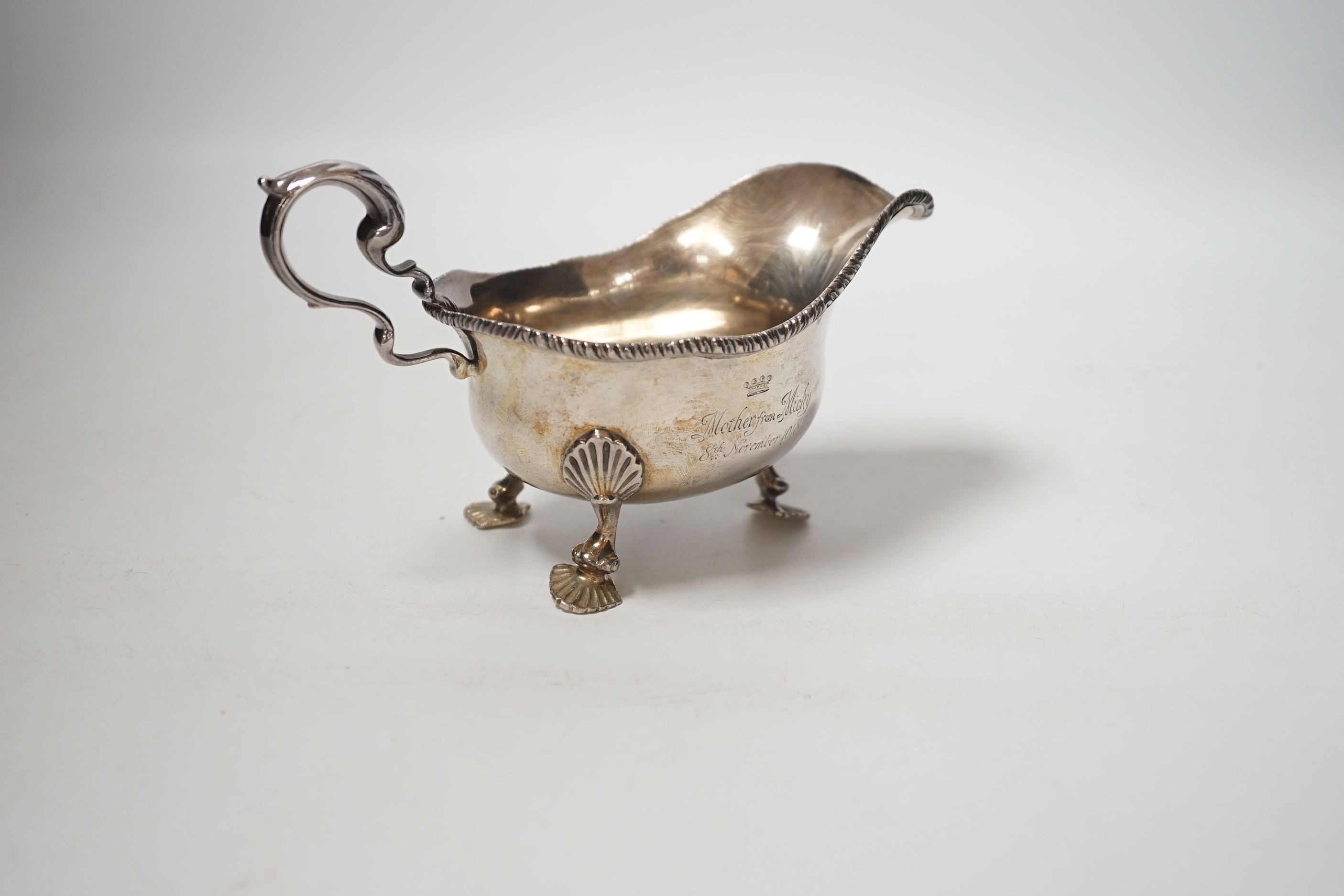 A George V silver sauceboat, on three shell feet, Thomas of New Bond Street, London, 1918, length 17cm, 8oz.